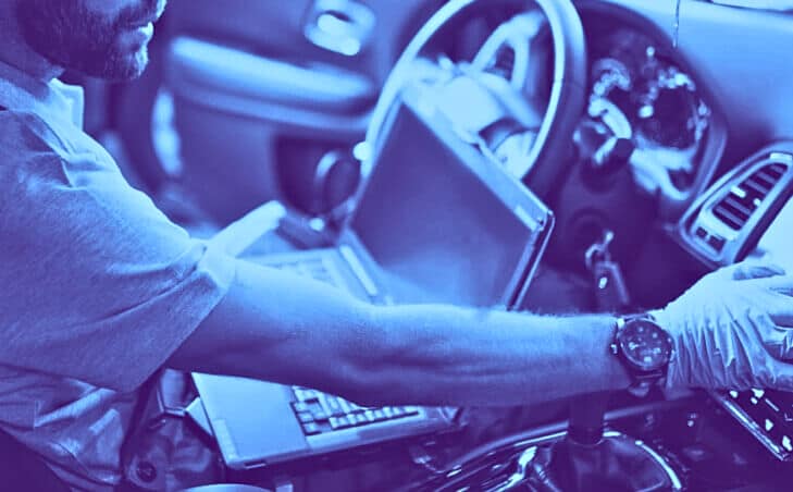 Technician diagnosing European vehicle with scanner